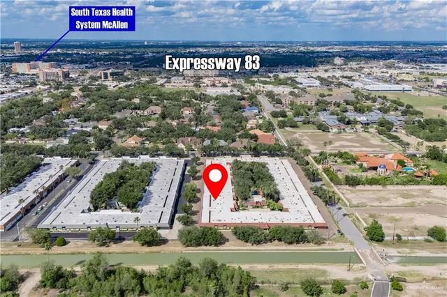 an aerial view of a house with a yard and lake view