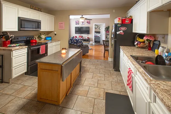 a kitchen with a stove top oven and cabinets
