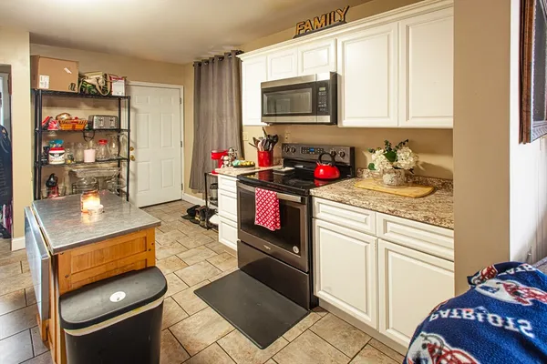 a kitchen with stainless steel appliances granite countertop a stove and a microwave