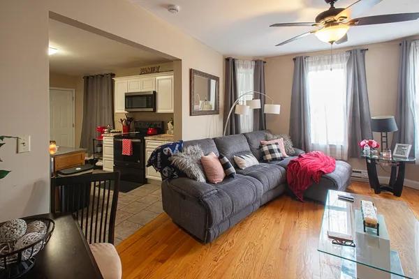 a living room with furniture and wooden floor