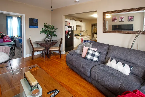 a living room with furniture and flowers