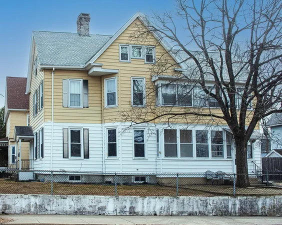 a view of a brick house with large windows