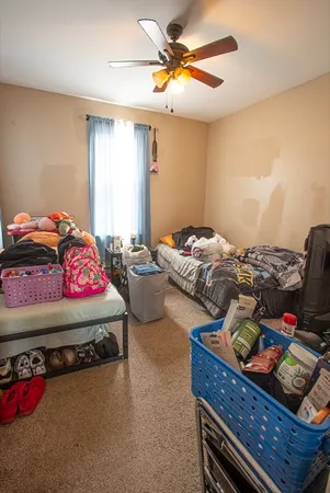 a bedroom with bed and a chandelier
