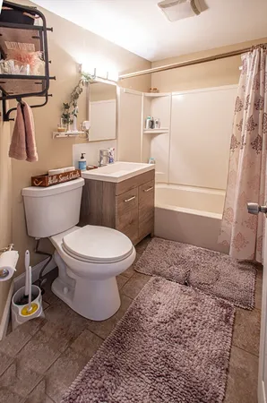 a bathroom with a toilet a sink and bathtub