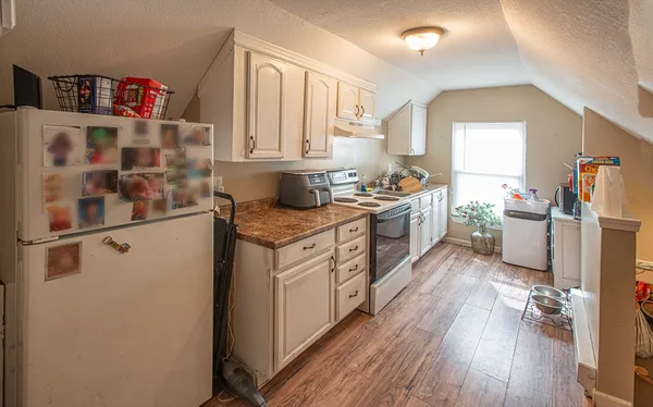 a kitchen with a sink stove and cabinets