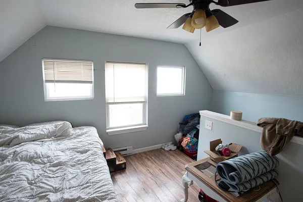a living room with furniture and a dresser