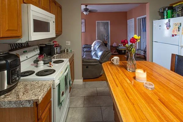 a kitchen with wooden floor and stainless steel appliances