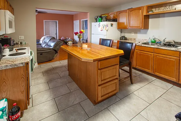 a kitchen with stainless steel appliances a stove a sink a counter top space and cabinets