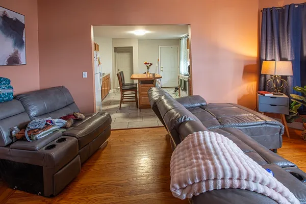 a living room with furniture and a large mirror