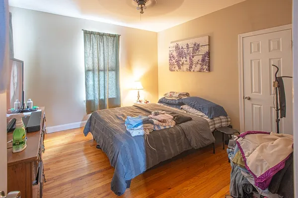 a bedroom with a bed and a window