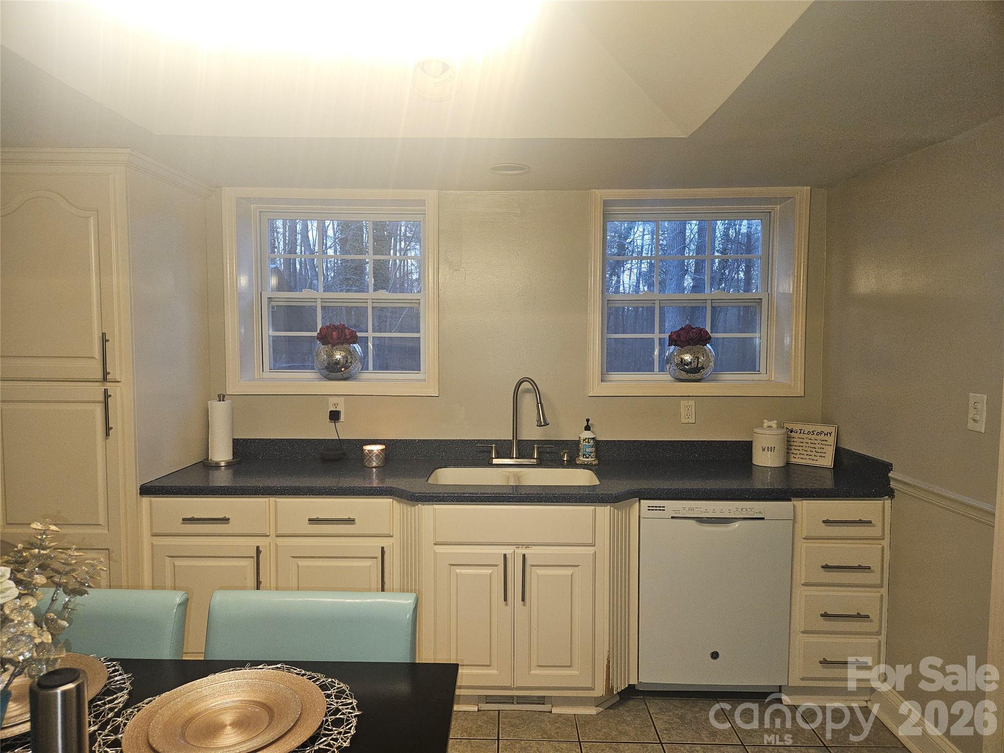 313 Mountain Creek Road Albemarle, NC 28001 - Photo 11 of 23 a kitchen with granite countertop a sink a stove and a window