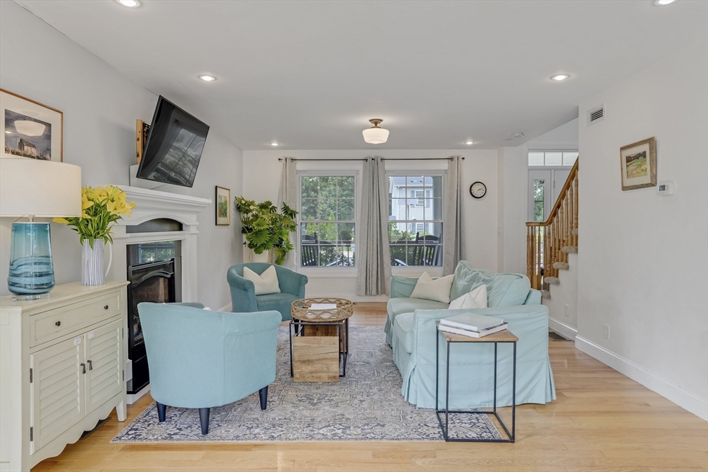 128-136 Spring Street Tisbury, MA 02568 - Photo 13 of 42 a living room with furniture a large window and a fireplace