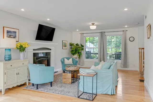 a living room with fireplace furniture and a flat screen tv