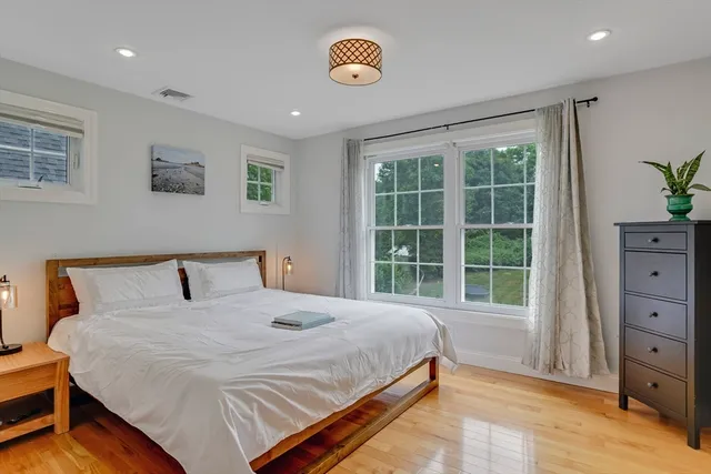 a bedroom with a large bed and a window