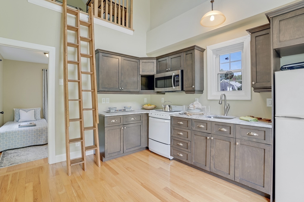 128-136 Spring Street Tisbury, MA 02568 - Photo 30 of 42 a spacious bathroom with a granite countertop sink and a mirror