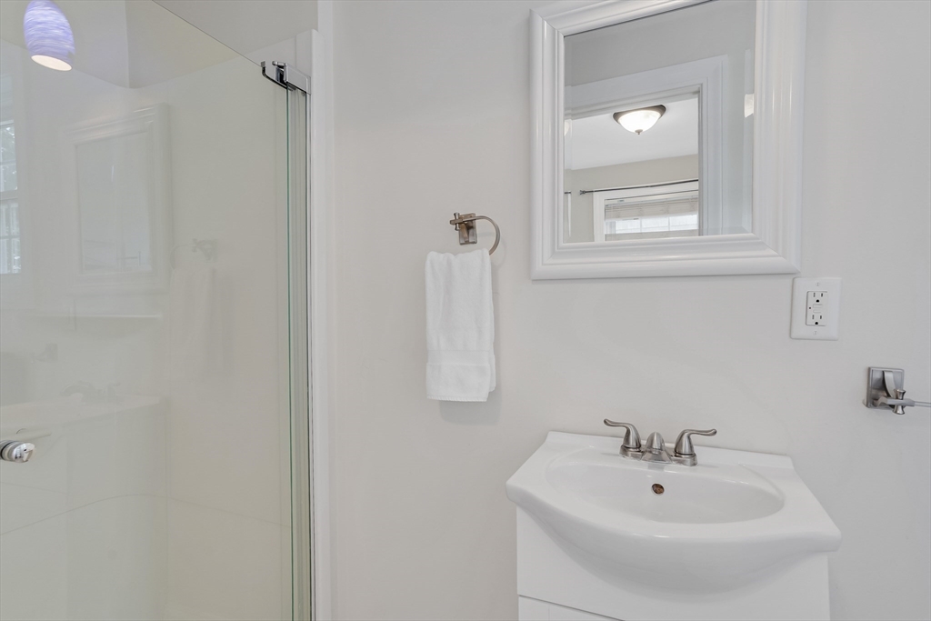 128-136 Spring Street Tisbury, MA 02568 - Photo 33 of 42 a bathroom with a sink and a mirror