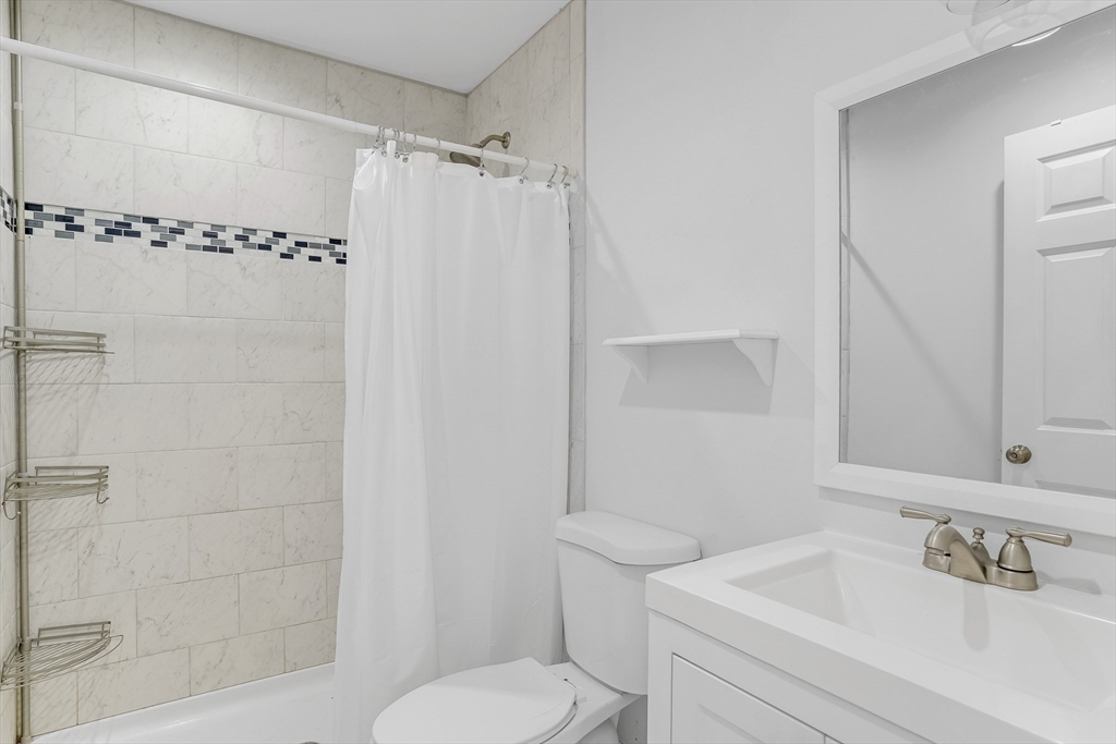 128-136 Spring Street Tisbury, MA 02568 - Photo 36 of 42 a bathroom with a sink toilet and shower