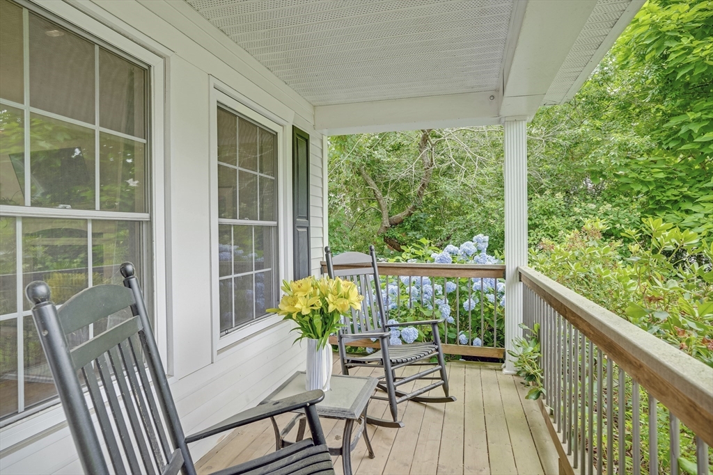 128-136 Spring Street Tisbury, MA 02568 - Photo 5 of 42 a view of a balcony with wooden floor and outdoor seating