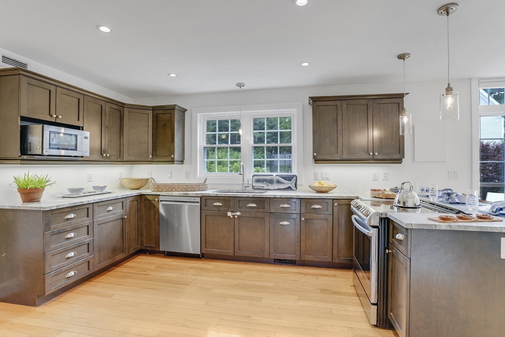 128-136 Spring Street Tisbury, MA 02568 - Photo 7 of 42 a kitchen with a sink stove and microwave