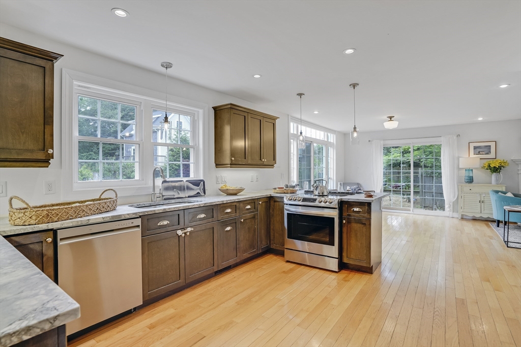 128-136 Spring Street Tisbury, MA 02568 - Photo 8 of 42 a large kitchen with stainless steel appliances granite countertop a stove and a sink