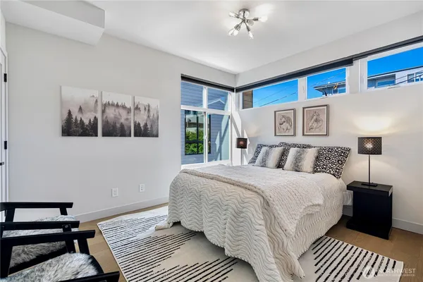 a spacious bedroom with a bed and a window
