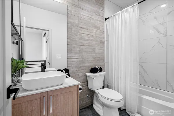 a bathroom with a sink a toilet and a mirror
