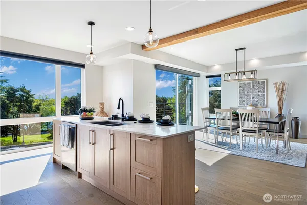 a very nice looking dining room with a large window and stainless steel appliances