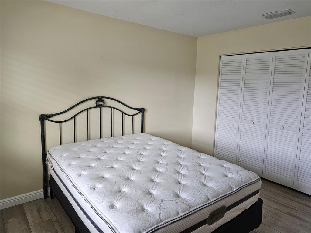 3304 Mcdill Road Bradenton, FL 34207 - Photo 11 of 23 a bedroom with a bed and wooden floor