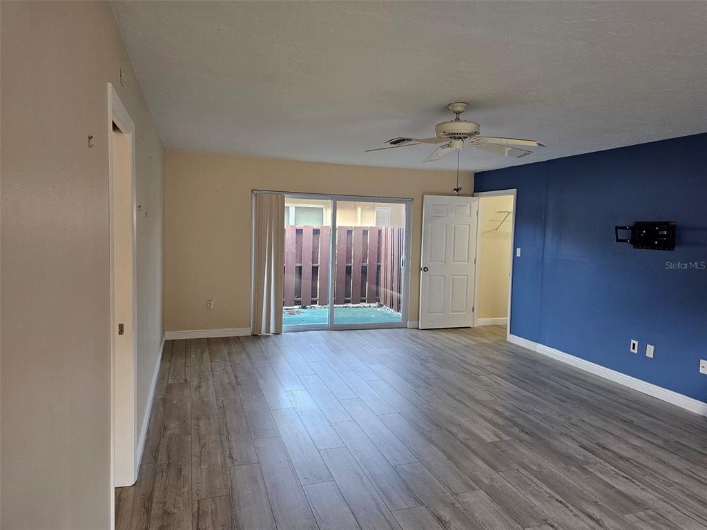 3304 Mcdill Road Bradenton, FL 34207 - Photo 4 of 23 an empty room with wooden floor and windows
