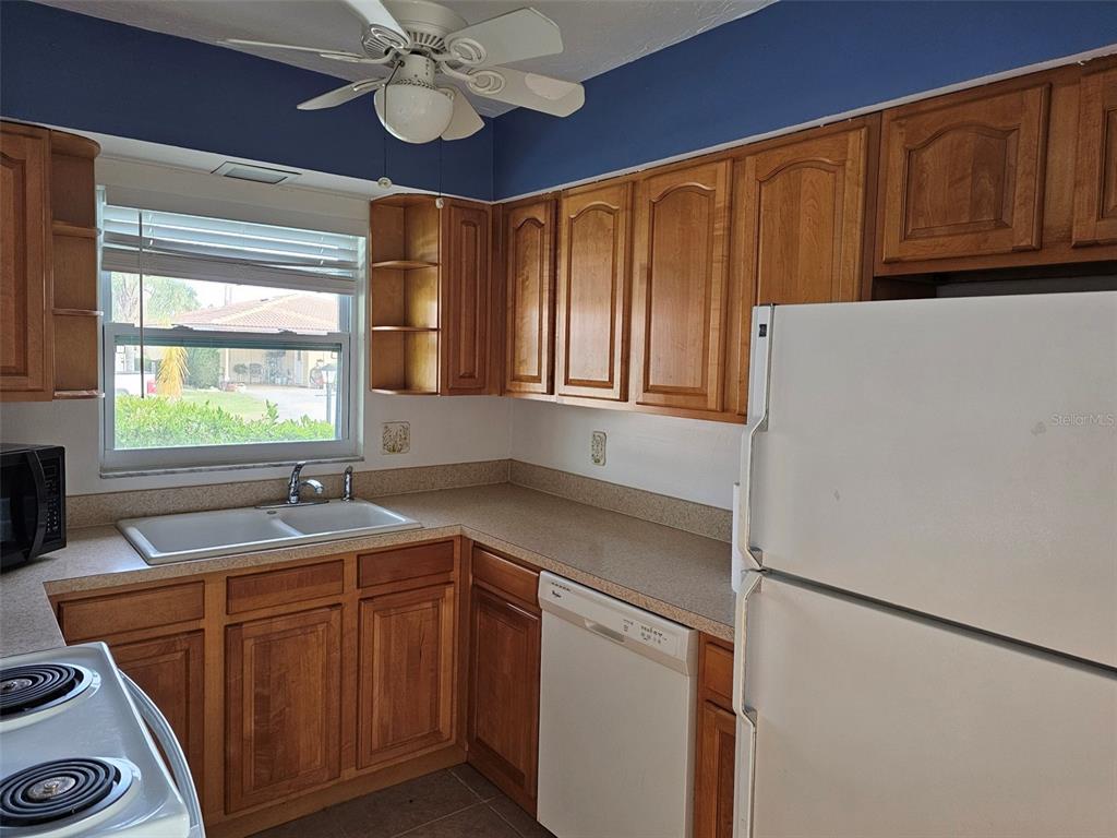 3304 Mcdill Road Bradenton, FL 34207 - Photo 6 of 23 a kitchen with stainless steel appliances granite countertop a sink dishwasher a refrigerator and cabinets with wooden floor