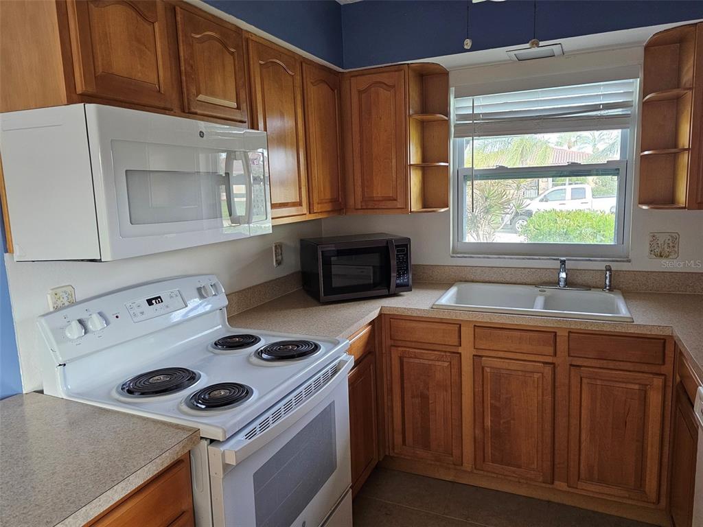 3304 Mcdill Road Bradenton, FL 34207 - Photo 7 of 23 a kitchen with a stove and a sink
