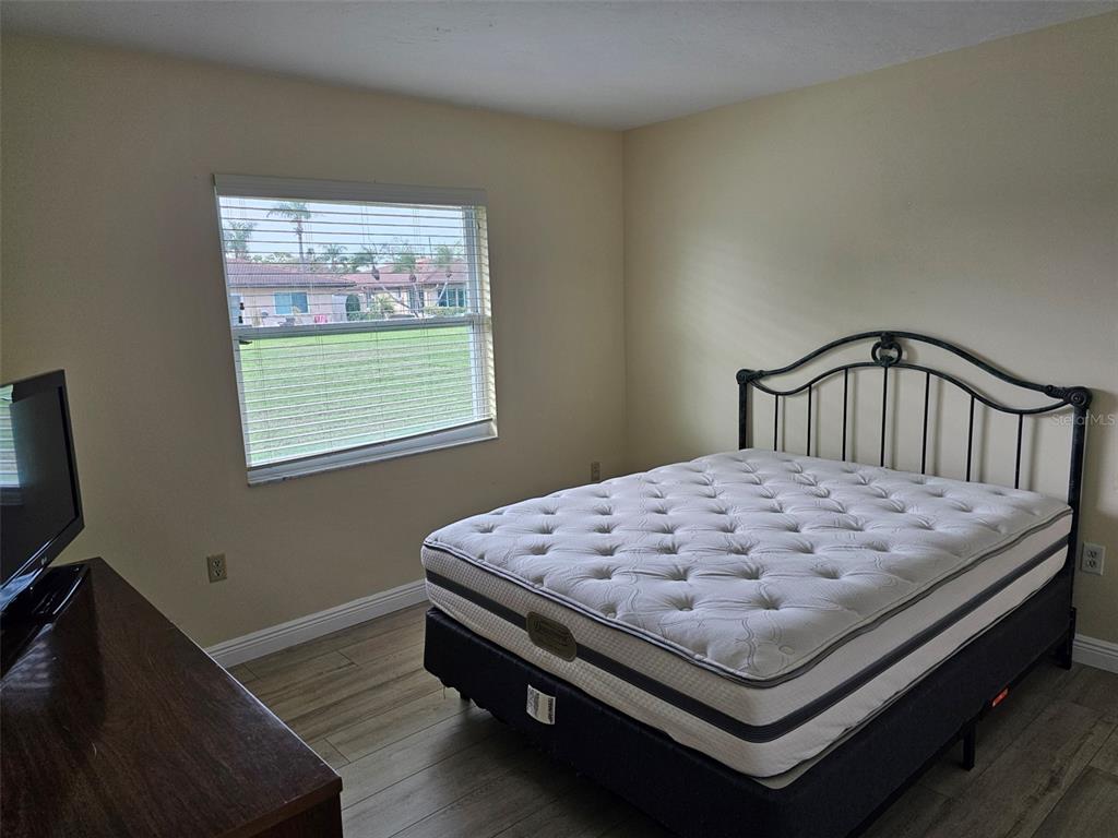 3304 Mcdill Road Bradenton, FL 34207 - Photo 9 of 23 a bed sitting in a bedroom next to a window