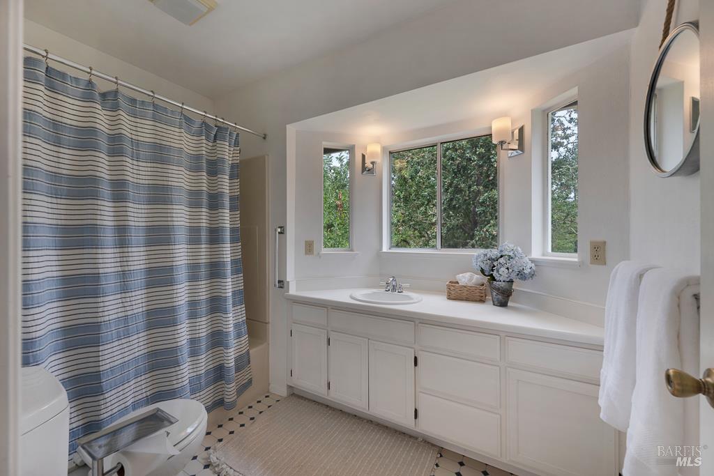 4542 Thomas Road Sebastopol, CA 95472 - Photo 29 of 60 a bathroom with a double vanity sink a mirror and a shower