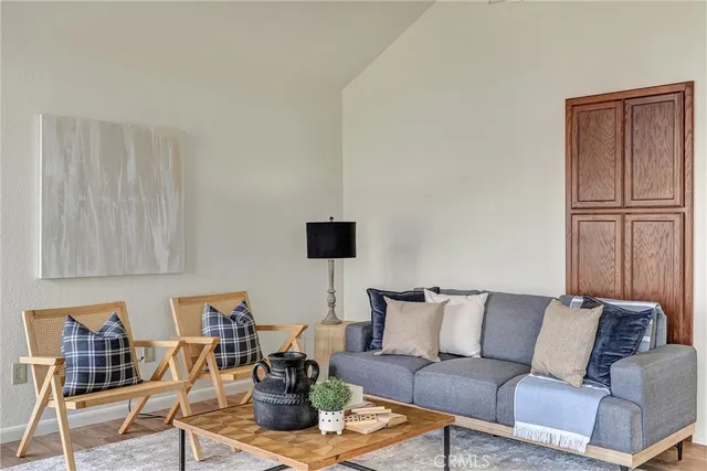 a living room with furniture and painting on the wall