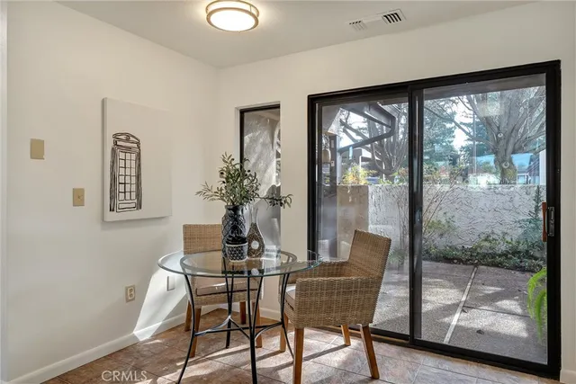 a dining room with furniture and front door