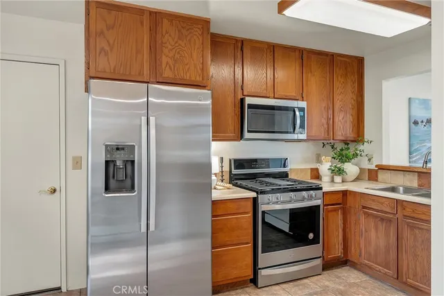a kitchen with a refrigerator stove and sink