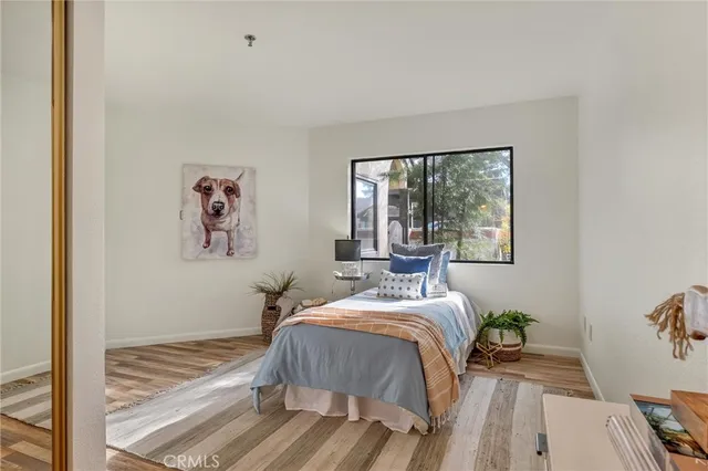 a bedroom with a bed and a large window