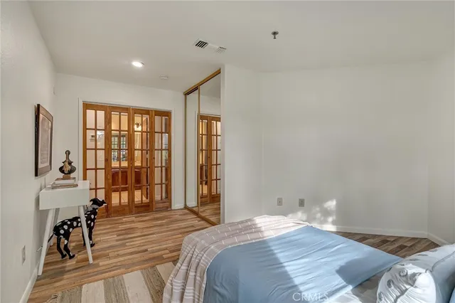 a bedroom with a bed and a flat tv screen