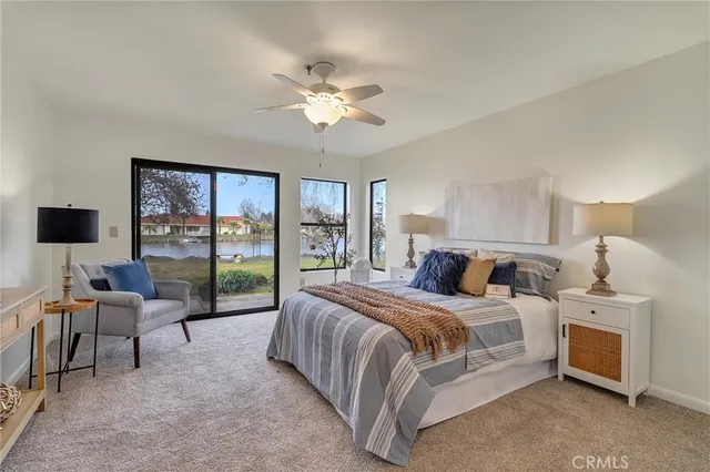 a bedroom with a large bed and a balcony view