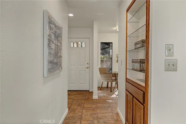 a view of a hallway with wooden shelves