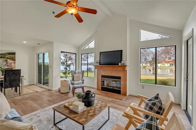 a living room with furniture a fireplace and a flat screen tv
