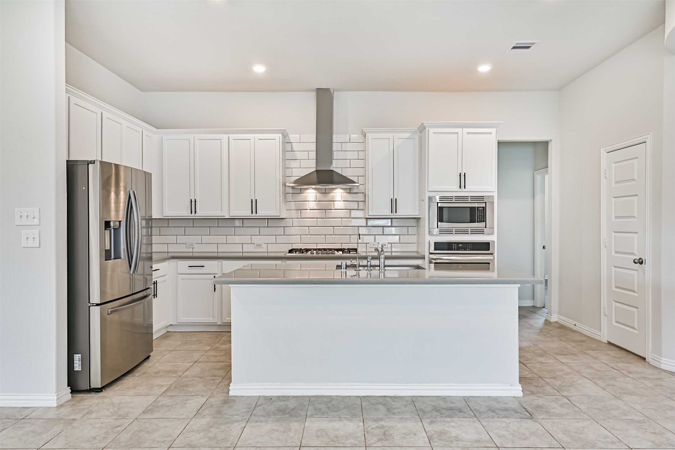 7019 Terra Drive Manvel, TX 77578 - Photo 21 of 41 a kitchen with stainless steel appliances granite countertop a refrigerator and a stove