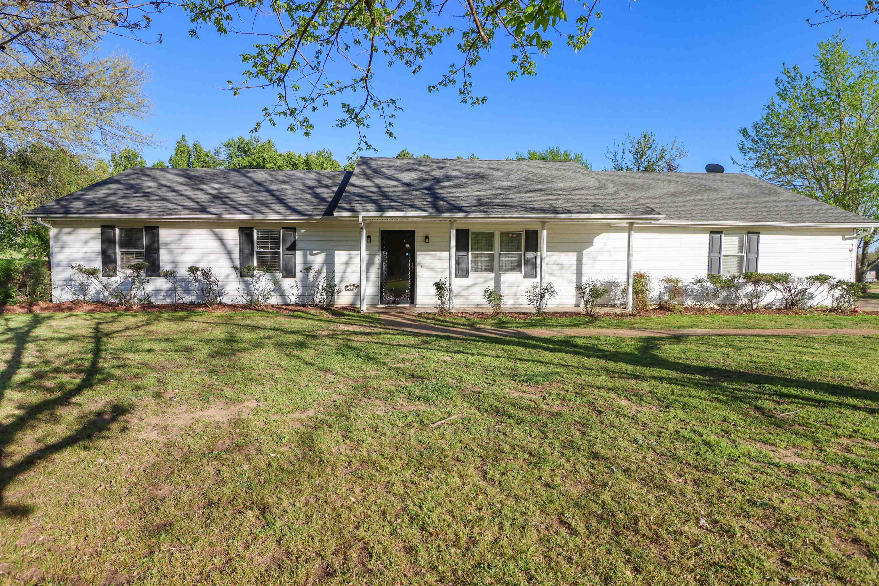 5551 Asbury Glimp Road Ripley, TN 38063 - Photo 1 of 28 a front view of a house with a garden