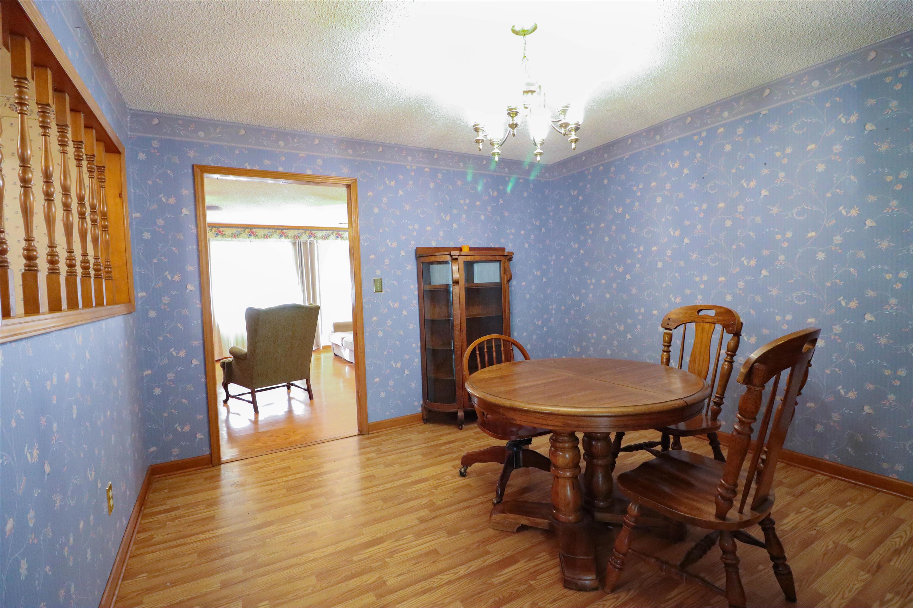 5551 Asbury Glimp Road Ripley, TN 38063 - Photo 11 of 28 a view of a dining room with furniture window and wooden floor