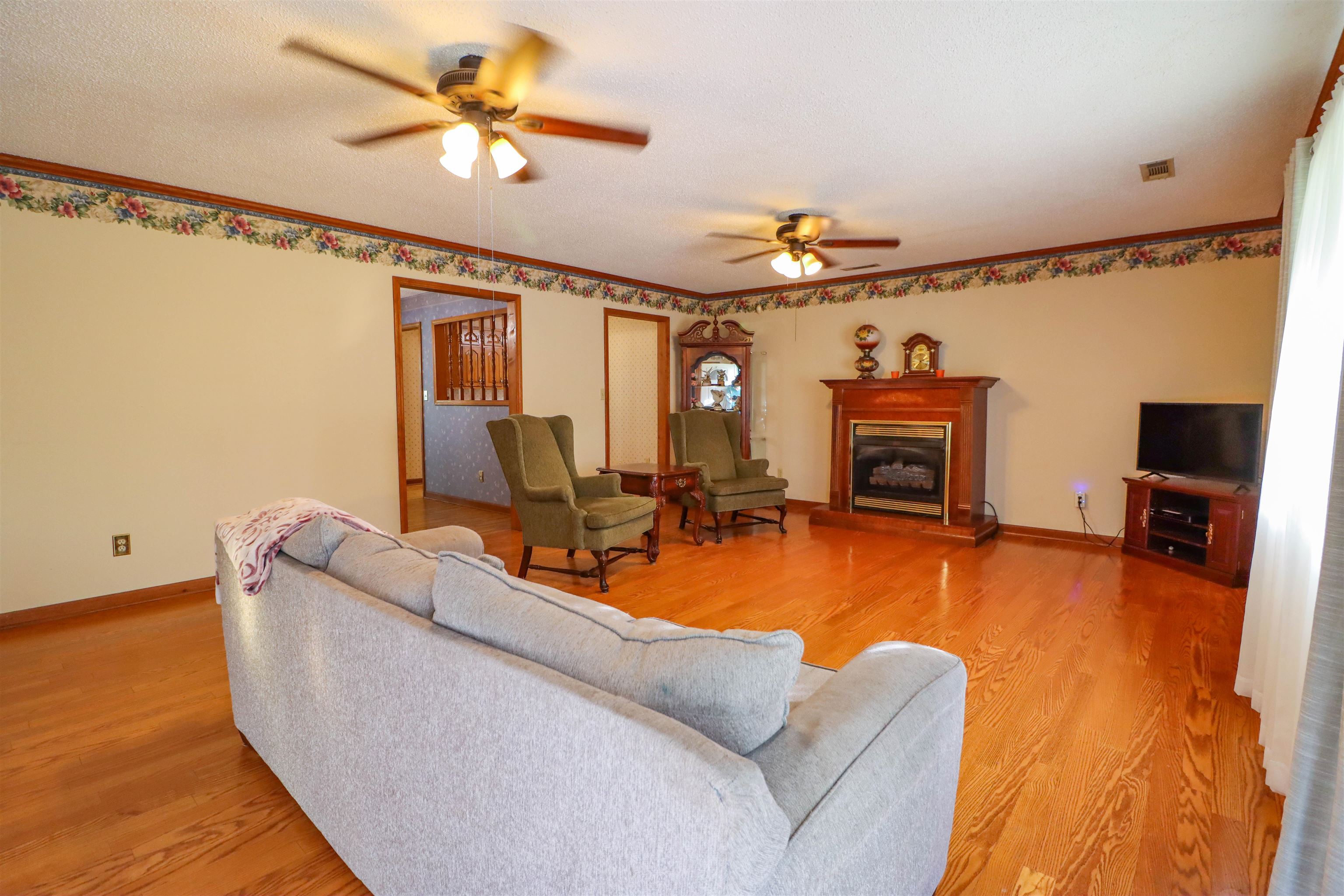 5551 Asbury Glimp Road Ripley, TN 38063 - Photo 14 of 28 a living room with furniture a fireplace and a flat screen tv