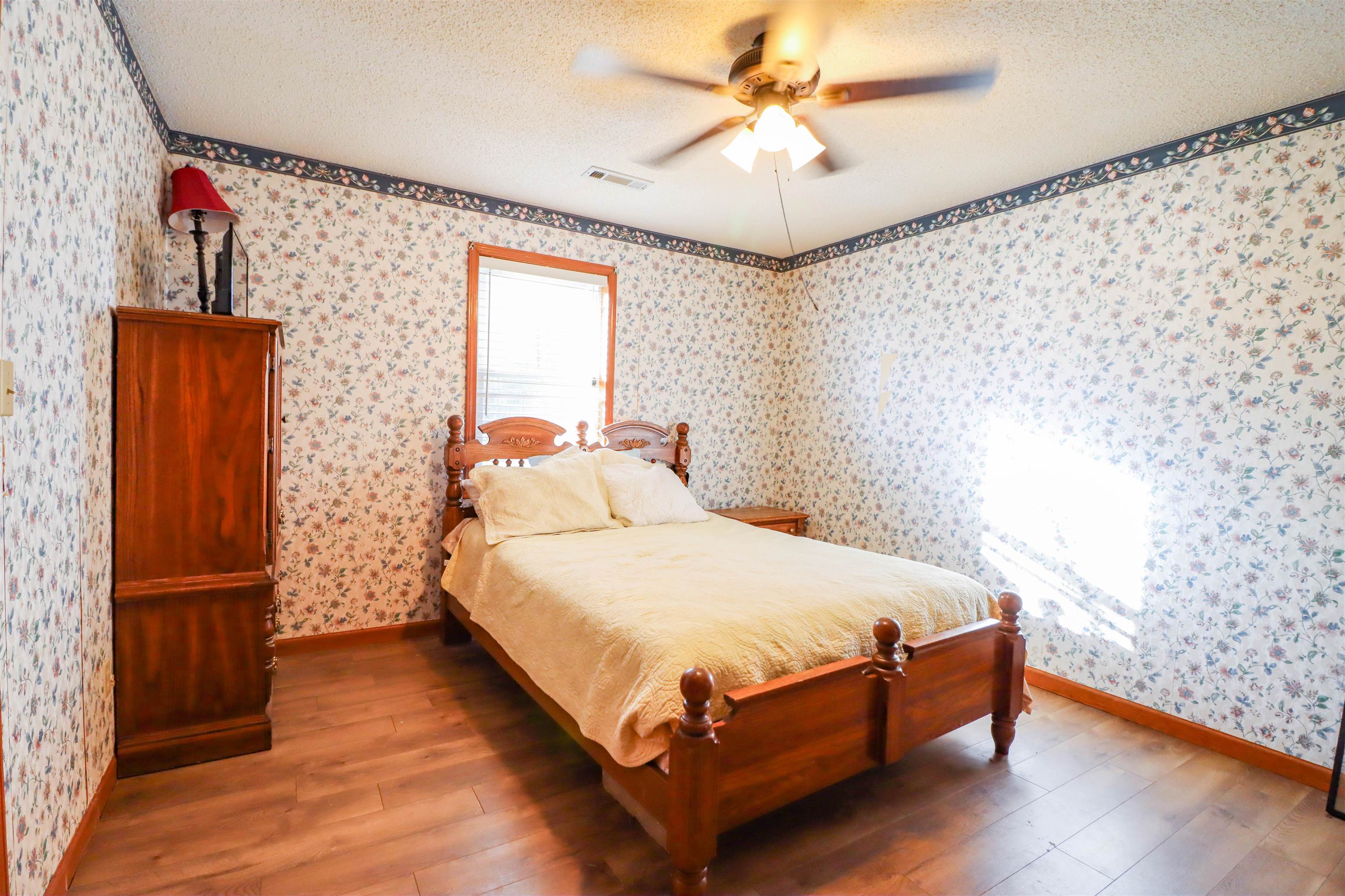 5551 Asbury Glimp Road Ripley, TN 38063 - Photo 17 of 28 a bedroom with a bed and wooden floor