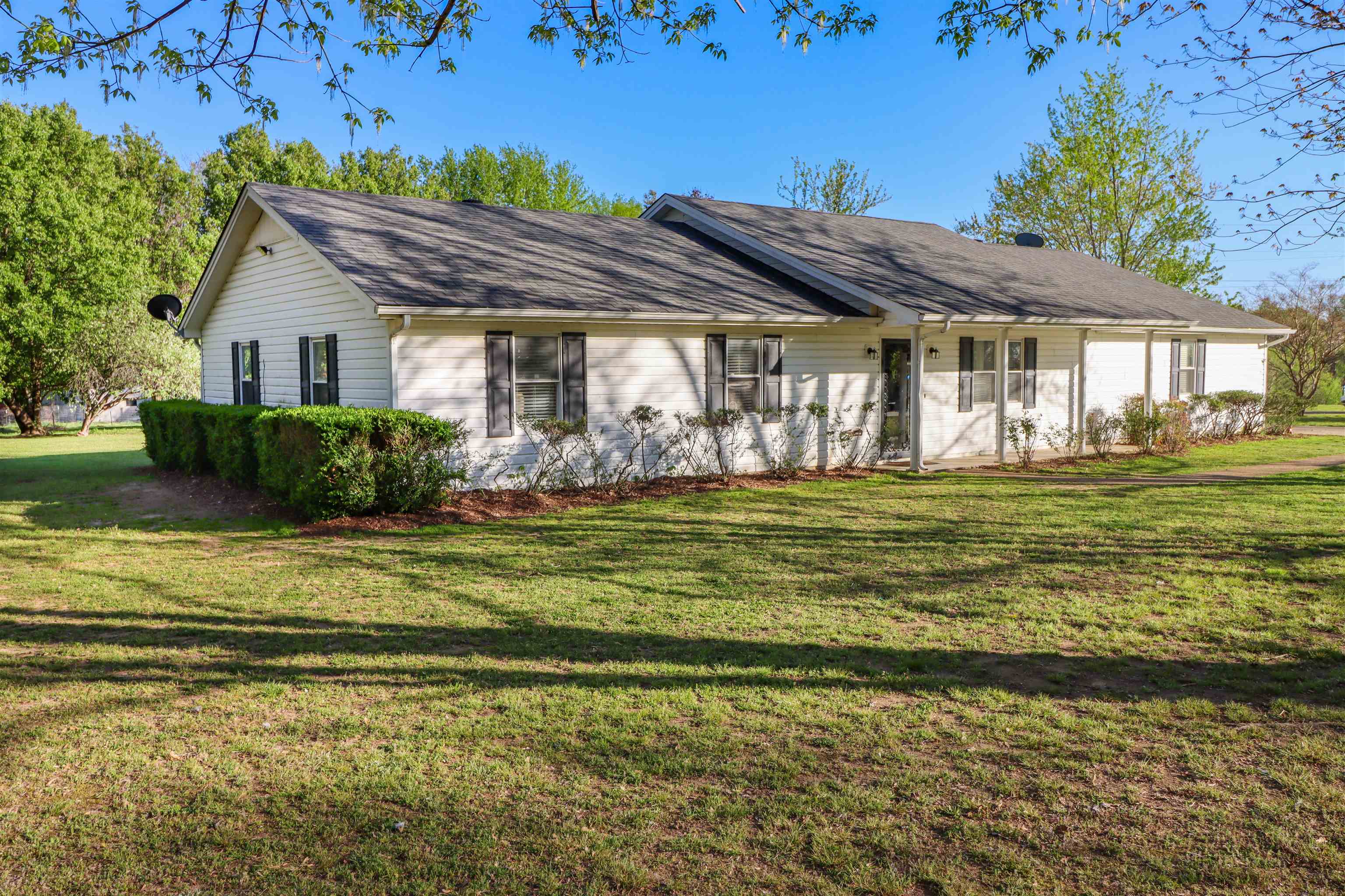 5551 Asbury Glimp Road Ripley, TN 38063 - Photo 2 of 28 a front view of a house with a garden