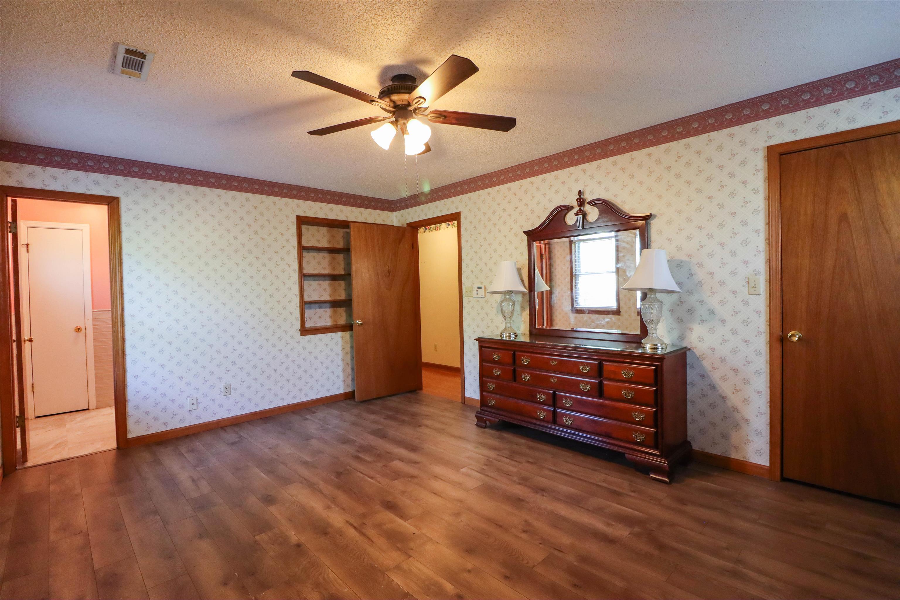 5551 Asbury Glimp Road Ripley, TN 38063 - Photo 22 of 28 a view of room with window and wooden floor