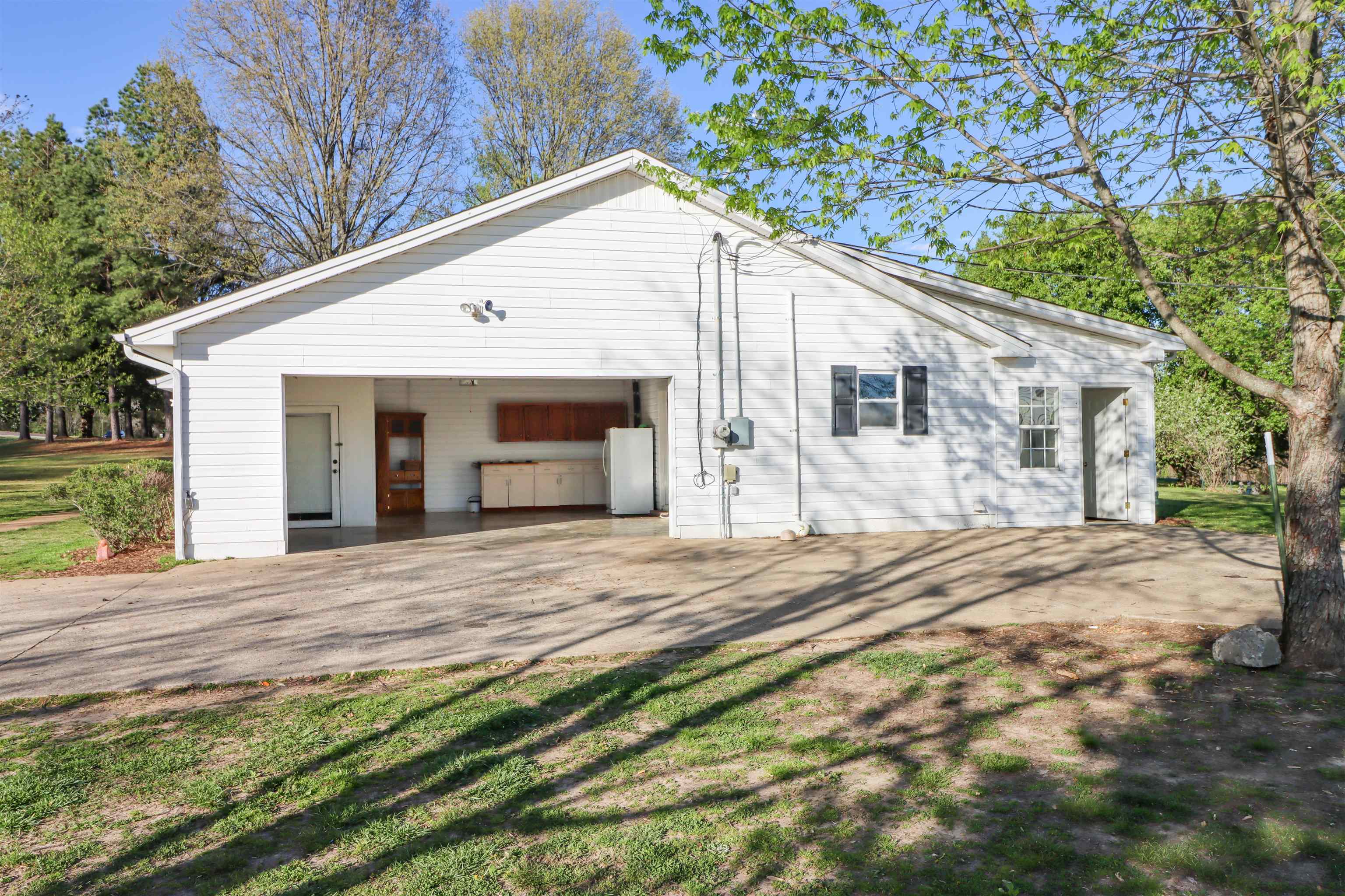 5551 Asbury Glimp Road Ripley, TN 38063 - Photo 4 of 28 a front view of a house with a yard and trees