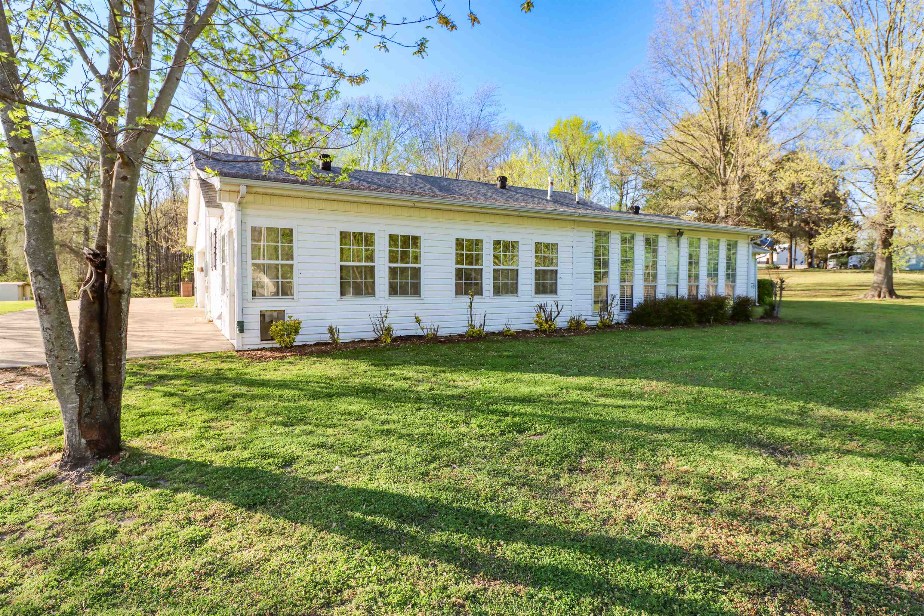 5551 Asbury Glimp Road Ripley, TN 38063 - Photo 5 of 28 a view of a house with a garden